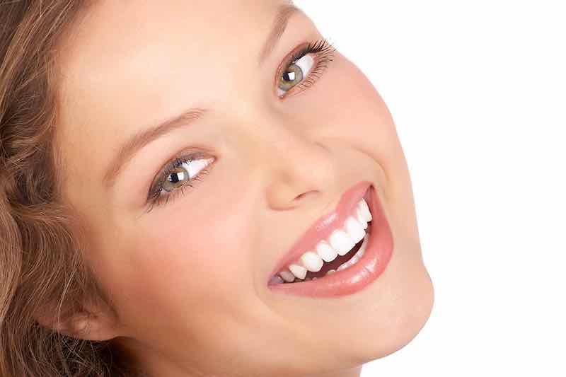 Beautiful young woman smiling. Isolated over white background